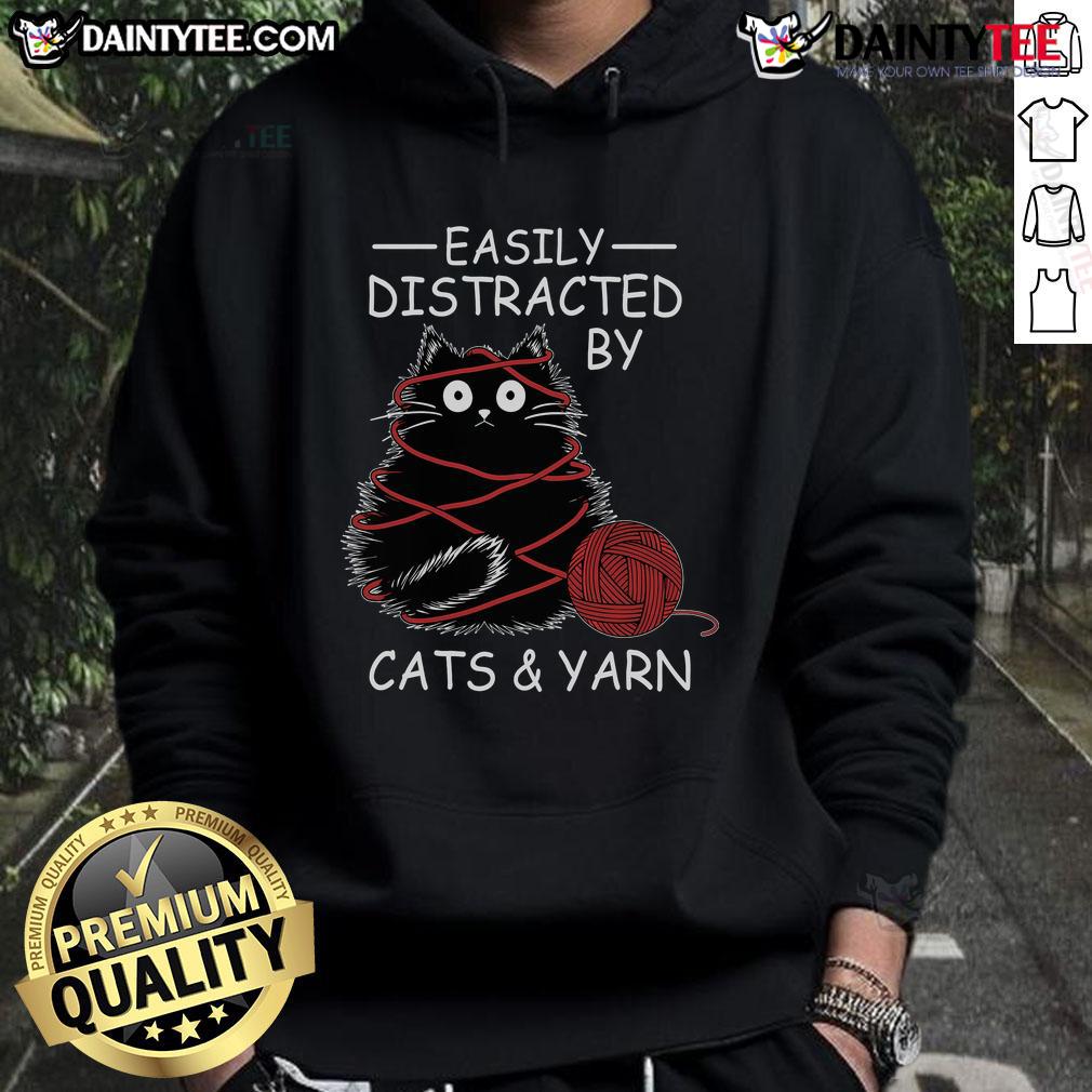 Adorable kitten lover in a crochet hoodie, easily distracted by cats and yarn, showcasing a fun and cozy style.