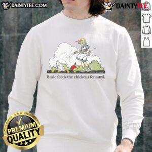 Adorable Susie wearing a 'Cute Susie Feeds The Chicken' sweatshirt, playfully interacting with chickens outdoors.