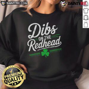 Funny St. Patrick's Day sweatshirt featuring 'Dibs on the Redhead' design with shamrocks, perfect for festive celebrations.