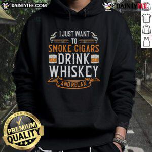 Relaxed man enjoying a nice Cuban cigar and whiskey in a cozy hoodie, embodying the perfect scotch drinker vibe.