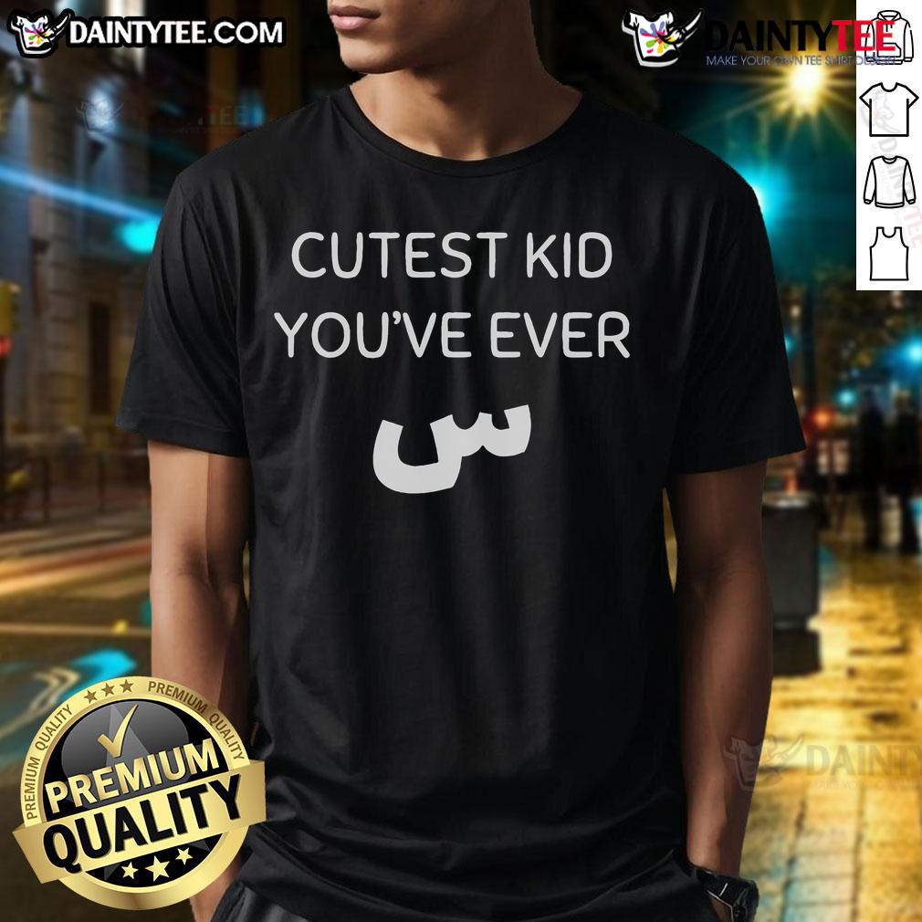 Alt Text: Cute kid wearing a Nicest Cutest Kid You've Ever Seen T-shirt, smiling joyfully in a sunny outdoor setting.