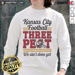 Alt Text: Kansas City Chiefs football sweatshirt featuring 'Three Peat We Ain't Done Yet' design on a leopard print background.