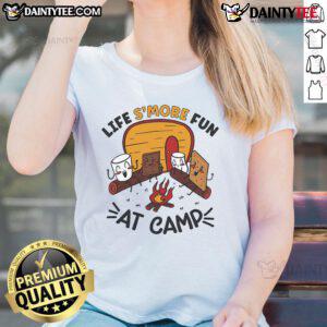 Women in 'Nice Life's More Fun at Camp' tee roasting marshmallows by a campfire, enjoying a fun camping experience.