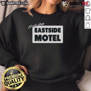 Cozy Nice Next Stop Eastside Motel sweatshirt displayed on a hanger against a rustic background, perfect for casual wear.