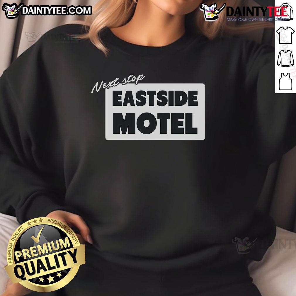 Cozy Nice Next Stop Eastside Motel sweatshirt displayed on a hanger against a rustic background, perfect for casual wear.