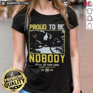 Good Stick To Your Guns Proud To Be Nobody Ladies Tee featuring a bold graphic design on a stylish women's shirt.
