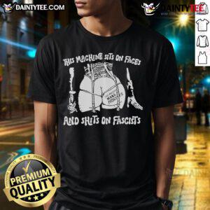 Alt Text: Hot This Machine Sits On Faces And Shits On Fascists T-Shirt design featuring bold text and vibrant colors.