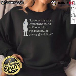 Alt Text: Yogi Berra sweatshirt featuring the quote Love is important, but baseball is pretty good too, celebrating humor and sports.