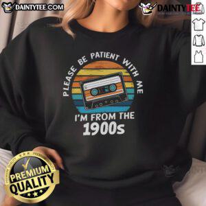 Alt Text: Vintage 'Please Be Patient With Me I'm From The 1900s' VHS tape sweatshirt against a sunset backdrop, showcasing retro style.