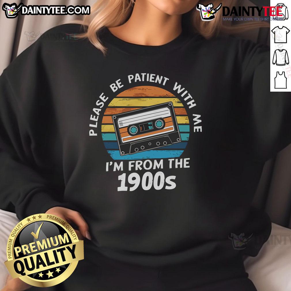 Alt Text: Vintage 'Please Be Patient With Me I'm From The 1900s' VHS tape sweatshirt against a sunset backdrop, showcasing retro style.