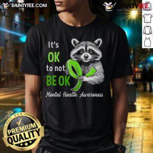 Funny raccoon graphic on a It's Okay To Not Be Okay mental health awareness T-shirt promoting positivity and self-acceptance.