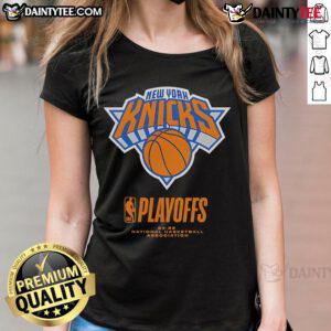 Excited New York Knicks fans in 2025 NBA Playoffs wearing 'Fanaticity' tee celebrating an alley-oop moment.