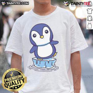 Cute penguin standing on an ice floe, featured on a trendy T-shirt design perfect for animal lovers and winter fashion.
