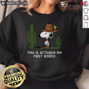 Alt Text: Cute Snoopy This Is Actually My First Rodeo sweatshirt featuring vibrant colors and playful design for fans.