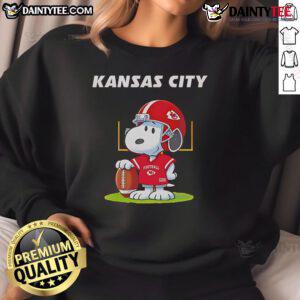 Alt Text: 2025 Nice Kansas City Chiefs X Peanuts Day sweatshirt featuring vibrant graphics and team logo for fans.
