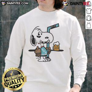 Cute Snoopy player in Seattle Kraken hockey sweatshirt showing middle finger, perfect for fans and collectors.
