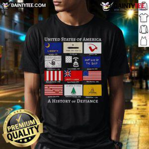 Good United States Of America A History Of Defiance Flags T-Shirt featuring bold flag graphics and patriotic design.