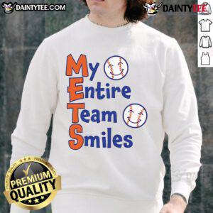 Happy Mets team members smiling in matching baseball sweatshirts, showcasing team spirit and camaraderie.
