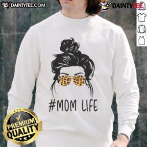 Stylish mom wearing leopard pattern shades and a cool messy bun sweatshirt, embodying awesome classy mom life.