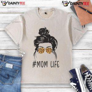 Classy mom life with leopard pattern shades, cool messy bun, and a washed t-shirt, showcasing effortless style.