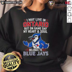 Cozy Toronto Blue Jays sweatshirt featuring 'I May Live In Ontario But On Game Day My Heart Belongs To The Blue Jays' design.