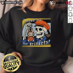 Alt Text: Awesome skeleton holding 'Labubu I Need My Trinkets' sweatshirt, showcasing a fun and quirky Halloween fashion statement.