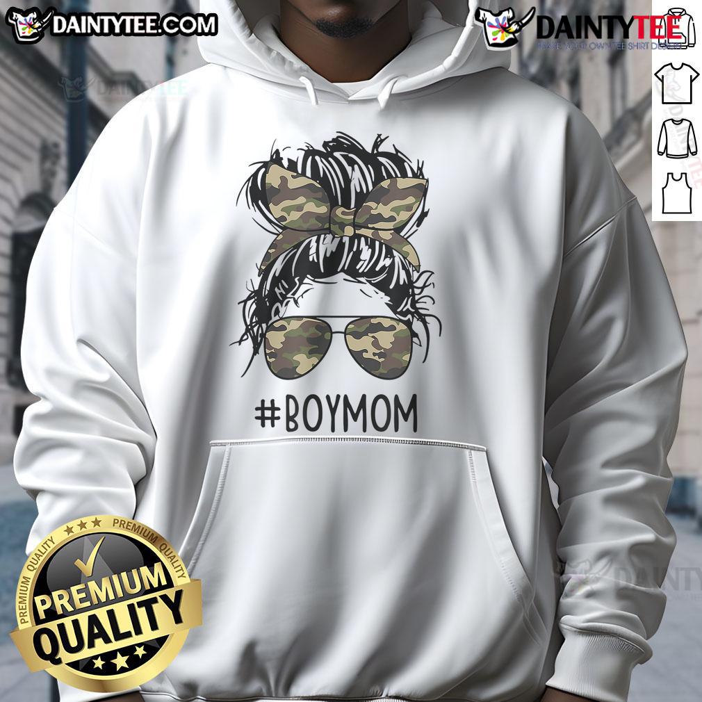 Mom of boys wearing a hoodie with a messy bun, embracing funny motherhood moments in a playful setting.