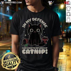 Funny cat wearing a In My Defense I Was Under The Influence Of Catnip t-shirt, showcasing playful feline humor.