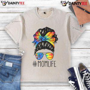 Mom with a funny messy hair bun wearing a tie-dye t-shirt, celebrating Mother's Day in a relaxed, playful style.