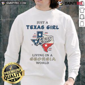 Cozy 'Good Just A Texas Girl Living In A Georgia World' sweatshirt displayed on a hanger, perfect for casual style.