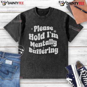 Pretty Please Hold I'm Mentally Buffering washed t-shirt displayed on a wooden background, showcasing its casual style.