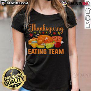Thanksgiving food lovers team enjoying a festive turkey day feast in matching ladies tees, celebrating together.
