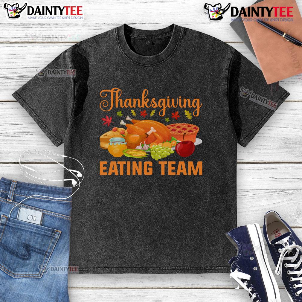 Awesome Thanksgiving eating team enjoying a turkey day feast in food lovers washed t-shirts, smiling and sharing dishes.