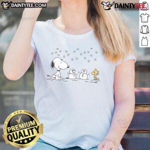 Alt Text: Cute Peanuts Snoopy and Woodstock winter snowman graphic on a ladies tee, perfect for cozy holiday outfits.