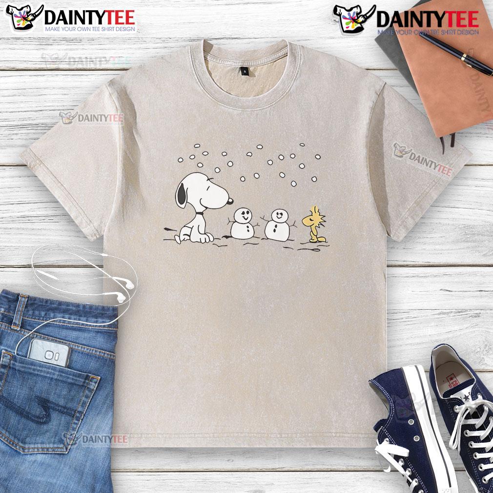 Alt Text: Cute Peanuts Snoopy and Woodstock winter snowman design on a washed t-shirt, perfect for cozy seasonal wear.