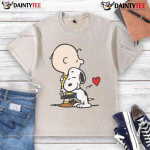 Cute Peanuts Snoopy hugging on a washed t-shirt, perfect for fans of classic cartoon apparel.