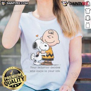 Alt Text: Cute Snoopy Peanuts tee with quote 'Your behavior decides who stays in your life' for ladies' fashion.