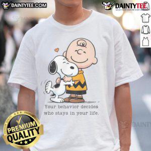 Alt Text: Cute Snoopy Peanuts t-shirt with the phrase Your Behavior Decides Who Stays In Your Life in vibrant colors.