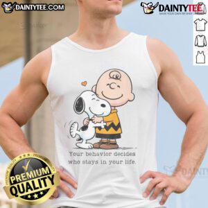 Cute Snoopy Peanuts tank top featuring the quote 'Your Behavior Decides Who Stays In Your Life' in vibrant colors.