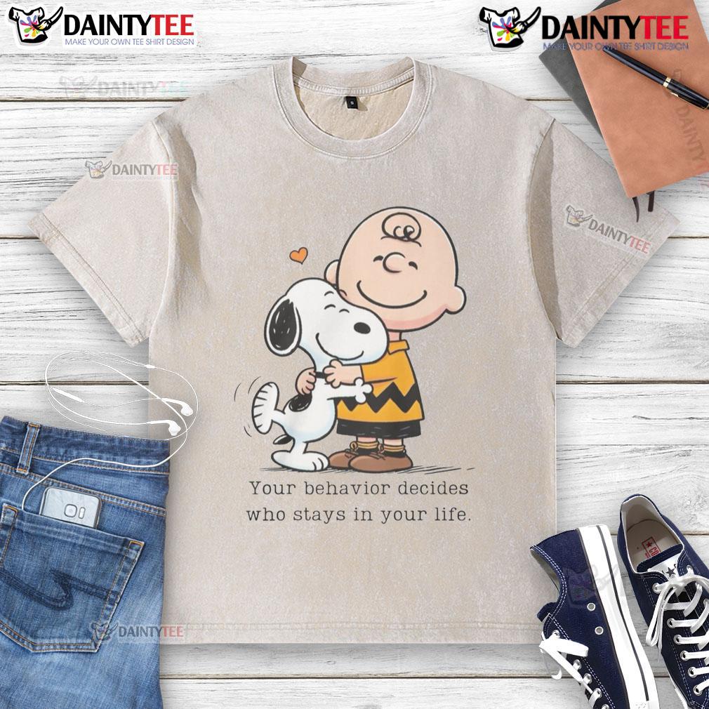 Alt Text: Cute Snoopy Peanuts graphic on a washed t-shirt: 'Your behavior decides who stays in your life' inspirational quote.