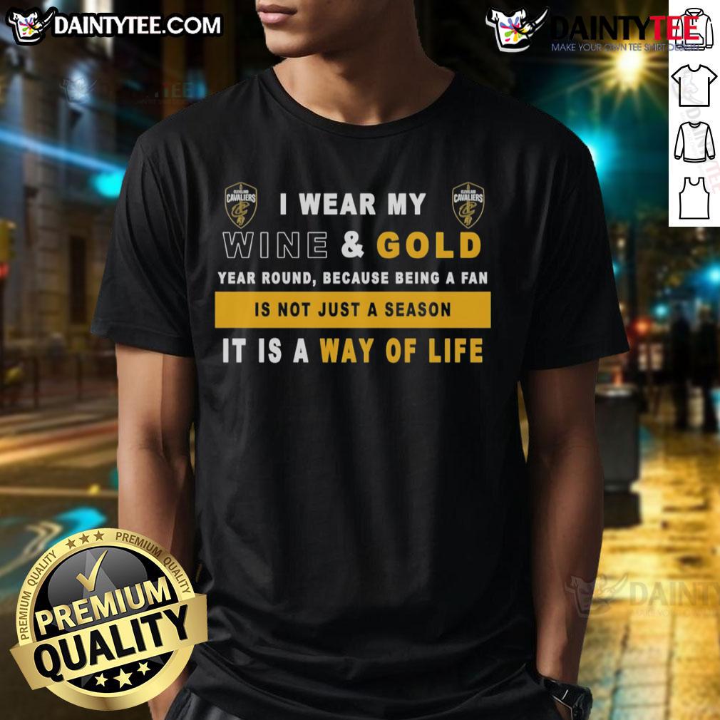 Alt Text: Cleveland Cavaliers fan wearing a wine and gold t-shirt that says 'I Wear My Wine And Gold Year Round' showcasing team pride.