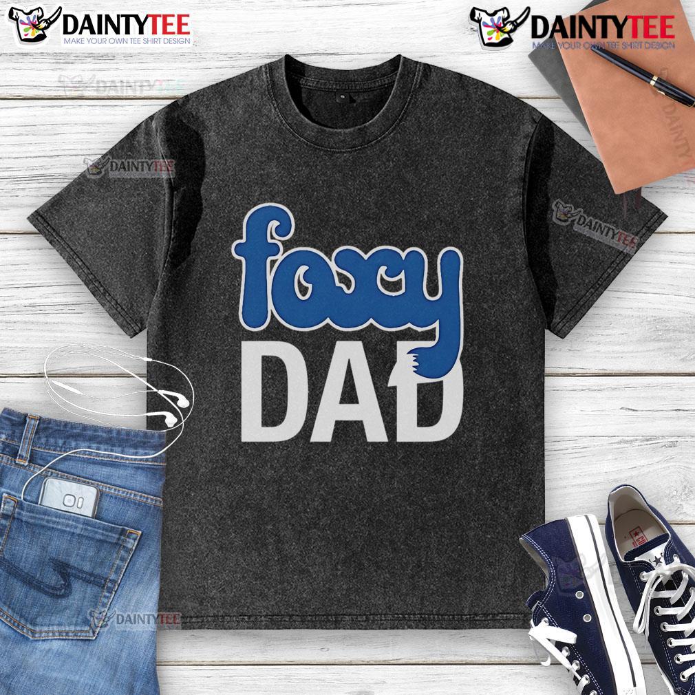 Nick Wilde wearing a 'Foxy Dad' washed t-shirt, showcasing a playful and stylish look in a vibrant setting.