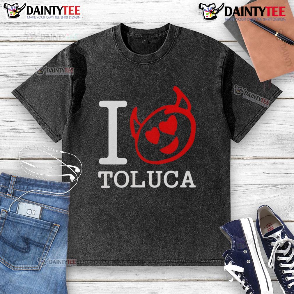 Good Red Devils I Love Toluca washed t-shirt displayed on a hanger, showcasing vibrant colors and casual style.