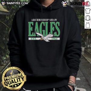 Happy fan wearing a Philadelphia Eagles hoodie celebrating Archbishop Shaw Eagles, established 1964, showcasing team spirit.