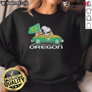Official Oregon Ducks X Snoopy sweatshirt featuring Woodstock driving a car, perfect for fans and cozy style.
