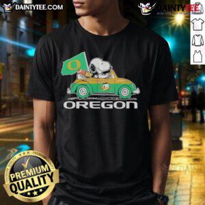 Official Oregon Ducks X Snoopy and Woodstock driving a car graphic t-shirt for fans and collectors.