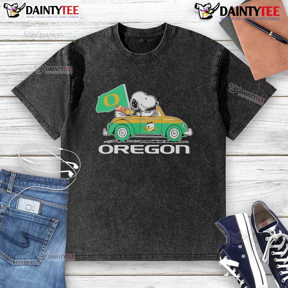 Alt Text: Official Oregon Ducks x Snoopy t-shirt featuring Snoopy and Woodstock driving a car, perfect for fans.