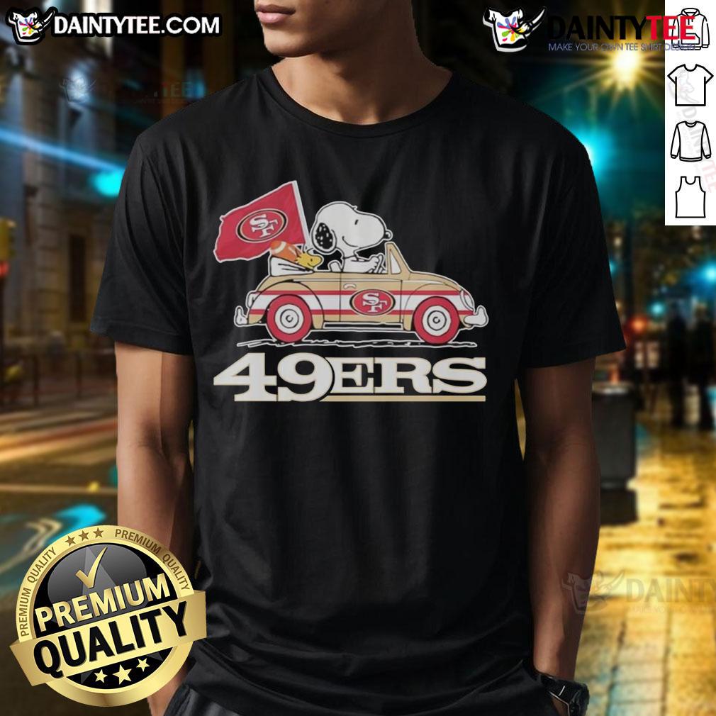Alt Text: Official San Francisco 49ers X Snoopy T-Shirt featuring Woodstock driving a car, perfect for fans and collectors.