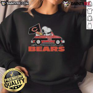 Snoopy and Woodstock driving a car on a Chicago Bears sweatshirt, perfect for fans and cozy wear.