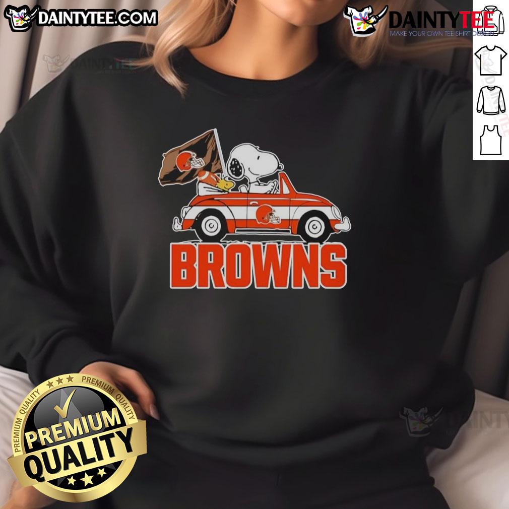 Alt Text: Official Snoopy and Woodstock driving car on Cleveland Browns sweatshirt, perfect for fans and cozy wear.